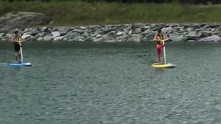 Two people on paddle boards in lake