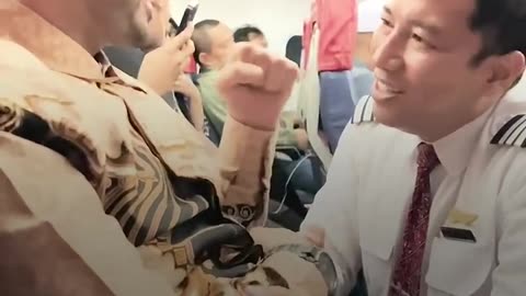 Indonesian pilot greets Palestinian man on plane.