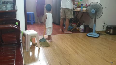 Incredible the 19-month-year old sweeps the house to help his parents