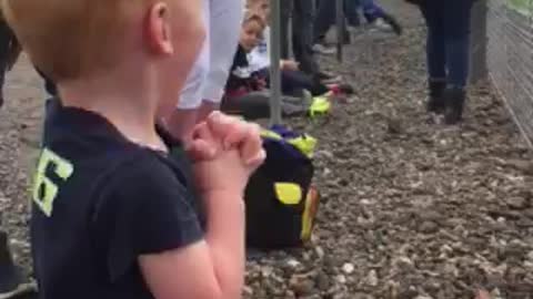 Boy Shakes With Excitement At Seeing Motorbikes Race For The First Time