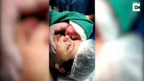 Emotional Moment Newborn Clings To Mother's Face