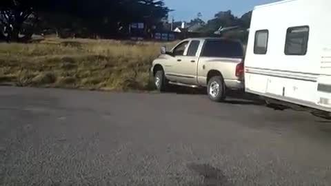 Man Tries to Get Long Trailer He is Towing Out of Tight Spot