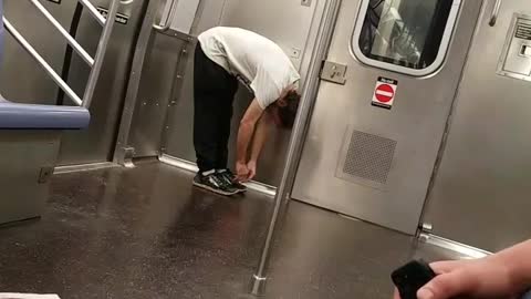Drunk guy jumps and walks around in subway train