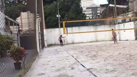 beach volleyball, mouthing with one hand!