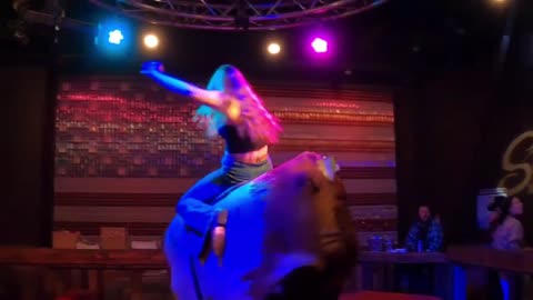Mechanical bull riding in Las Vegas: A bell-bottomed wrangler from the 1970s show her smooth skills