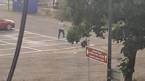 Man Punches Air in Parking Lot