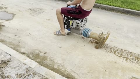 Construction Worker Takes Asphalt Compactor for a Drive