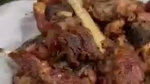 Street food very red hot meat tikka with tandoori roti from Peshawar