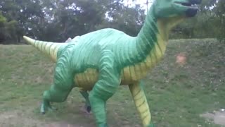 Sculpture of a green and yellow dinosaur at the science museum [Nature & Animals]
