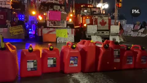 After police started seizing fuel from the Freedom Convoy truckers, a row of gas cans has been placed at Parliament Hill