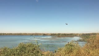 A Helicopter Crossing A River