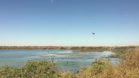A Helicopter Crossing A River