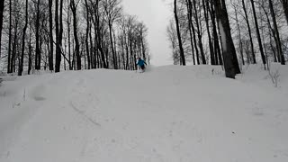 Blue jacket ski skier messes up and falls forward in snow front flip