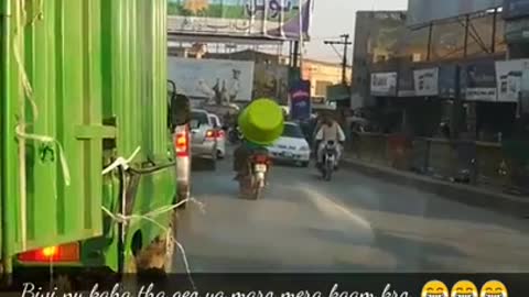 Pakistani man ride motorcycle with giant tub