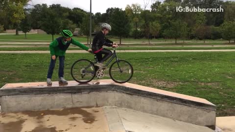 Boy in black striped pants fall forward bike