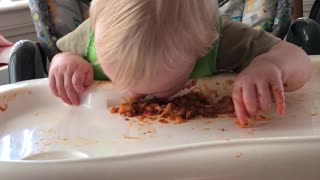 cute baby makes a mess while eating