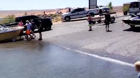 People pushing box into water