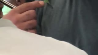 Guy hat grey shirt subway green bug on chest shoulder