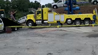 Towing Company Owners Use Crane and Car for Gender Reveal