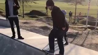 Beanie guy tries to drop in on concrete bowl falls off skateboard