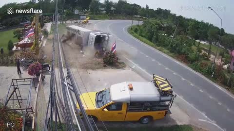 Truck loses control and flips over on road bend in Thailand