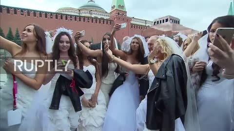 Russia: Putin Mobbed by Young models Dressed as Brides