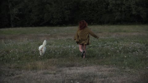 A dog running with the girl