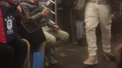 Guy with airpods raps out loud on subway train