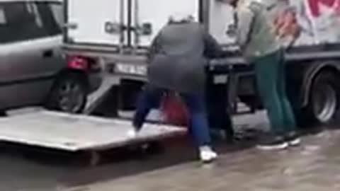 Watch: Trucker Uses Liftgate to Help Senior Get Into Car During Flood