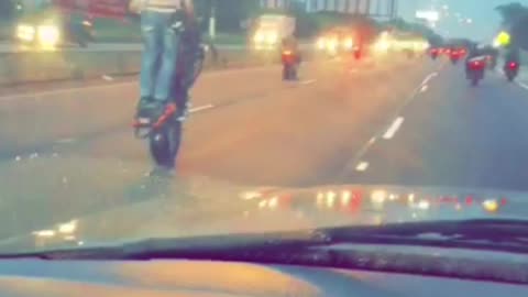 Group of Motorcyclists Do Stunts on Expressway