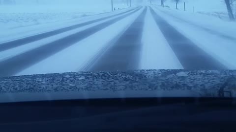 Driving on a snowing afternoon day