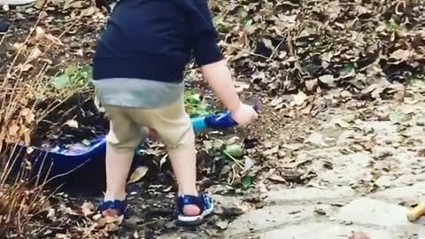 Little boy helps out with the yard chores