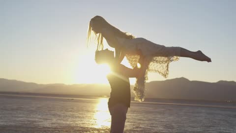 Cute Romantic Couple Dance On A Beach With Sunset