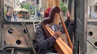 Musician Performs in Burned Out Bus