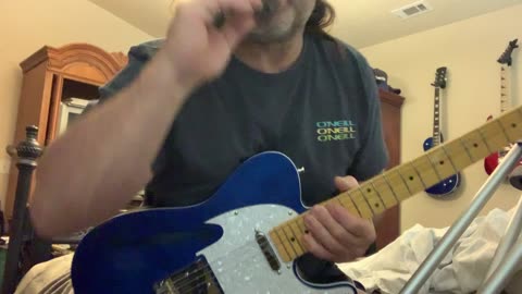 Recording guitar tracks in bedroom studio
