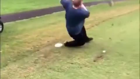 Man Slips on Grass While Taking Golf Shot