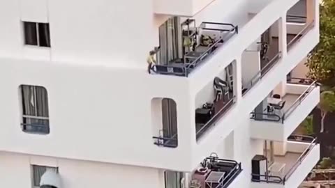Kid walking on the edge of a building. Parents nowhere to be seen