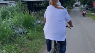 Cat Rides on Owner Riding a Bike