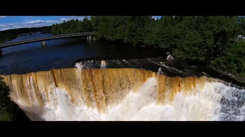 Breathtaking aerial flyover of a waterfall