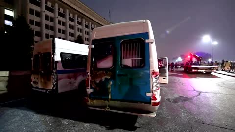 Abandoned police vans in Almaty as violent protests intensify