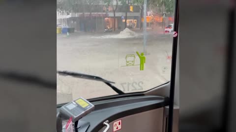 People drive through flooded streets in Spain