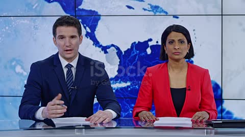 Indian anchorwoman and Caucasian anchorman presenting the news stock video