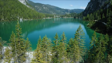 aerial footage over lake braies pragser wildsee and mountains in the background