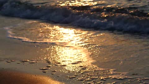 The beauty of the waves at sunset on the beaches of golden sand