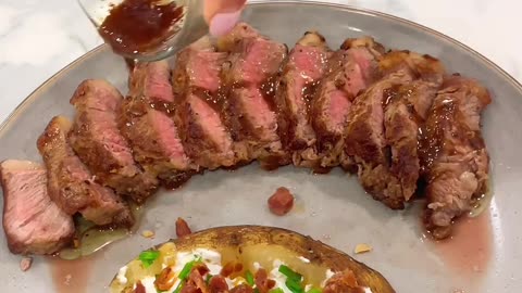 "Sizzling Steak Perfection: Indulge in Truffle Butter Magic with Delectable Baked Loaded Potatoes"