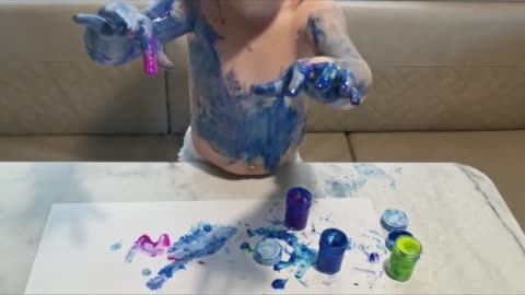 Baby Smurf covered in blue paint