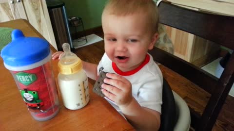 Toddler mimics father's cynical laugh