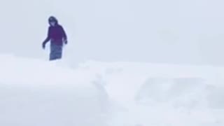 Kid sleds off snowy roof top and falls into pile of snow