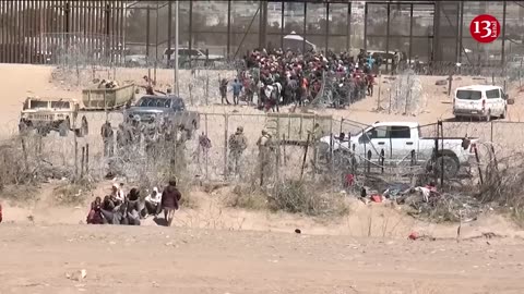 Migrants break through security barrier at US border