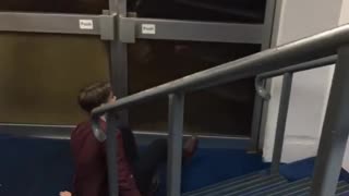 Video me maroon jacket slides down rail falls